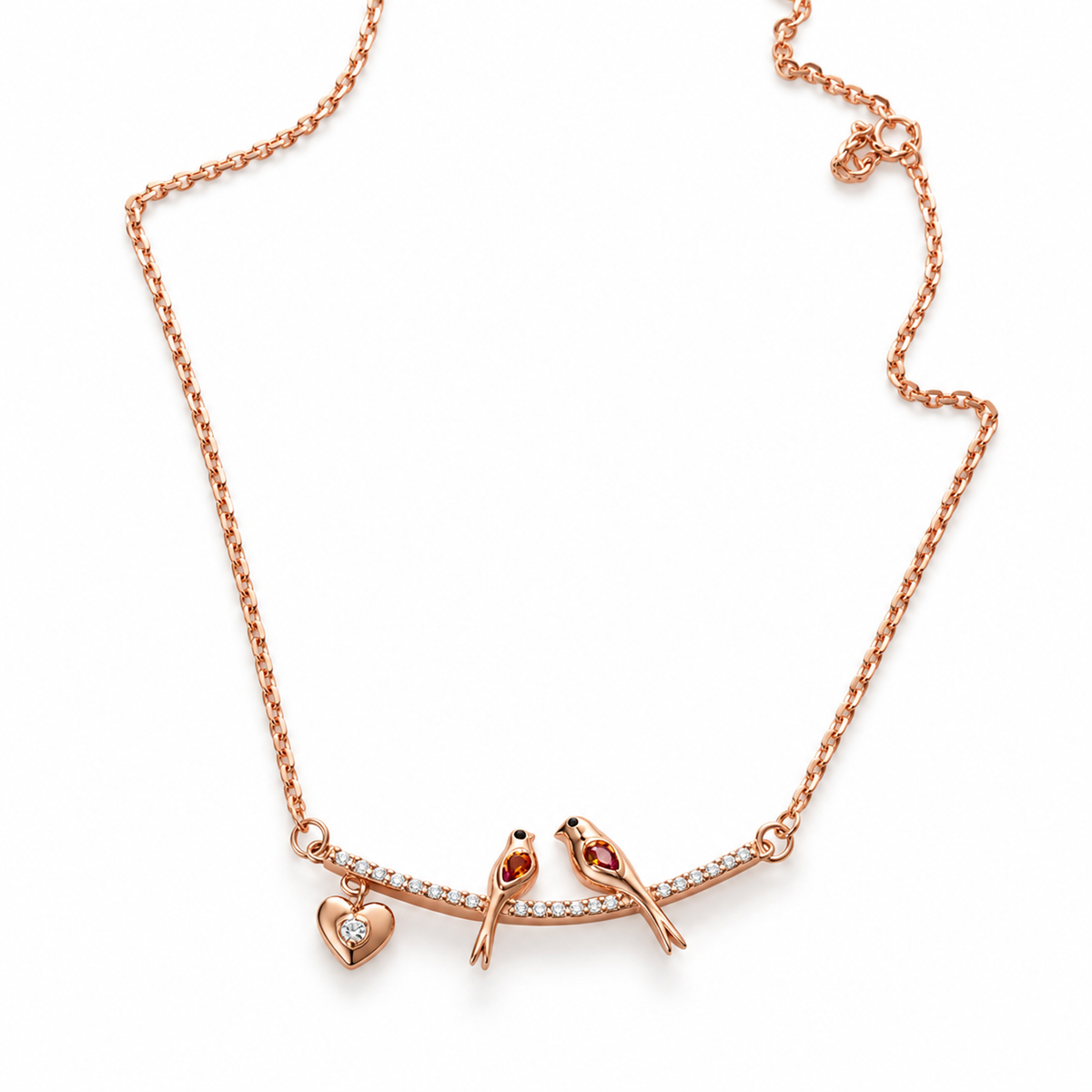 Rose gold lovebirds necklace displayed on ivory linen with a blush pink ribbon.