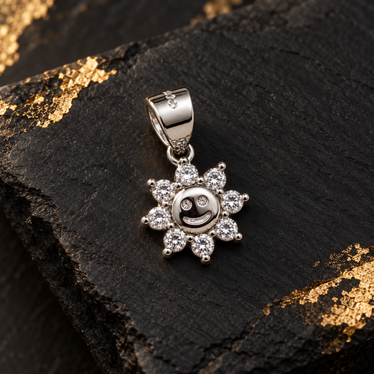 Silver sun pendant on an ivory ceramic tray beside soft blush silk.