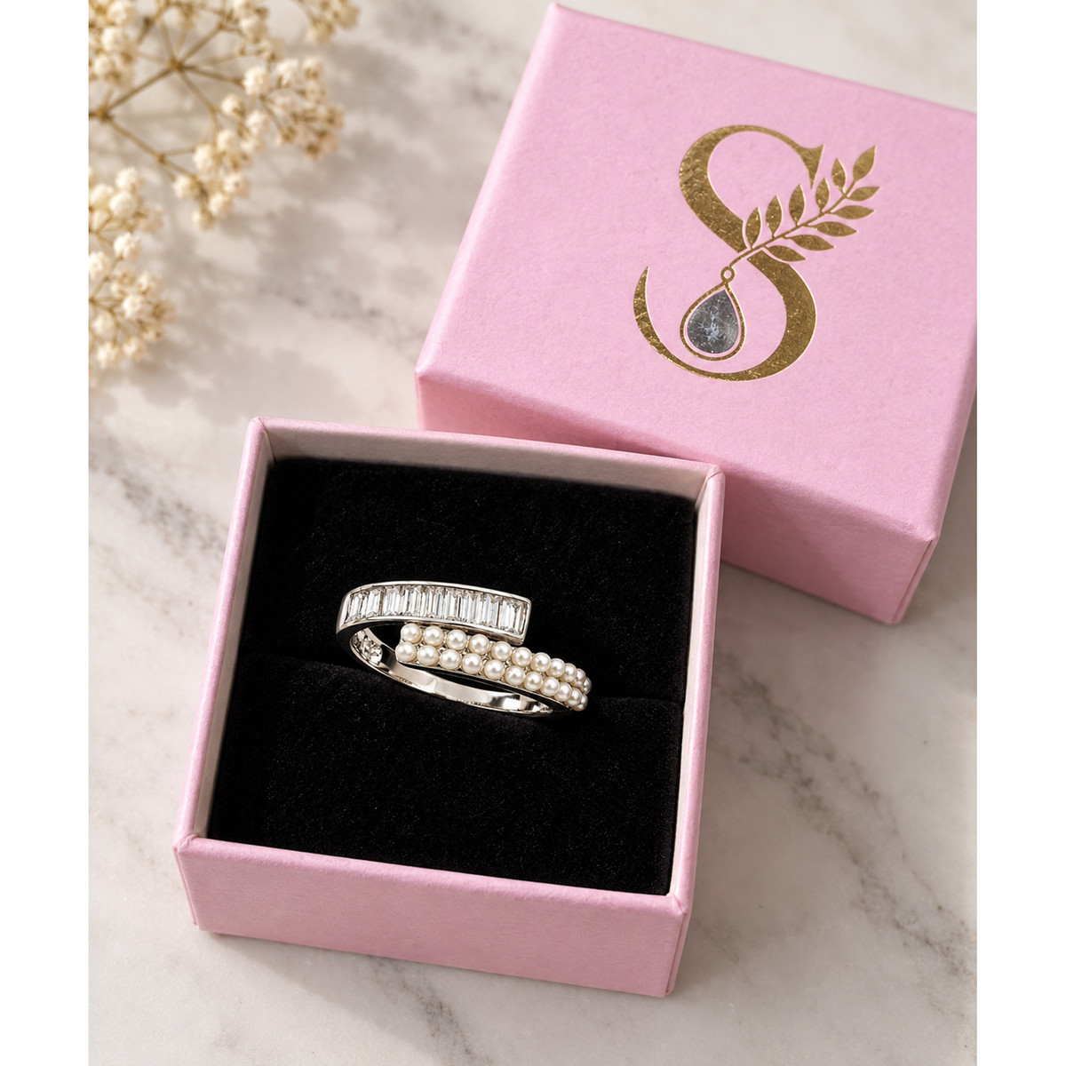 Silver bypass ring in a pale pink Silvanya jewellery box.