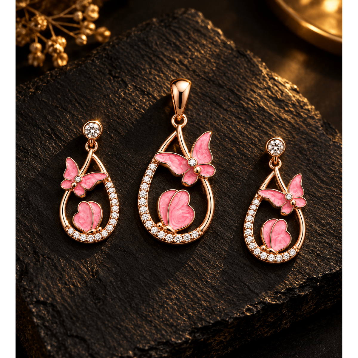 Butterfly pendant and earrings set illuminated on textured black slate background.