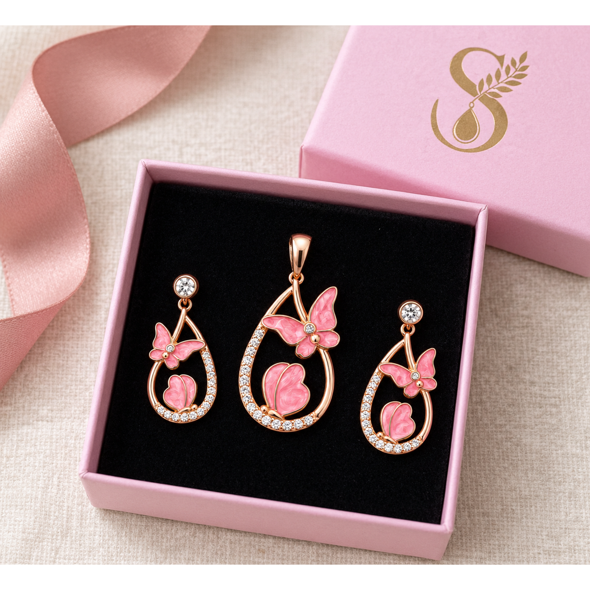 Rose gold butterfly jewellery set presented in a pink Silvanya gift box with black velvet interior.