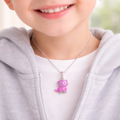Child wearing a necklace with a purple dinosaur pendant