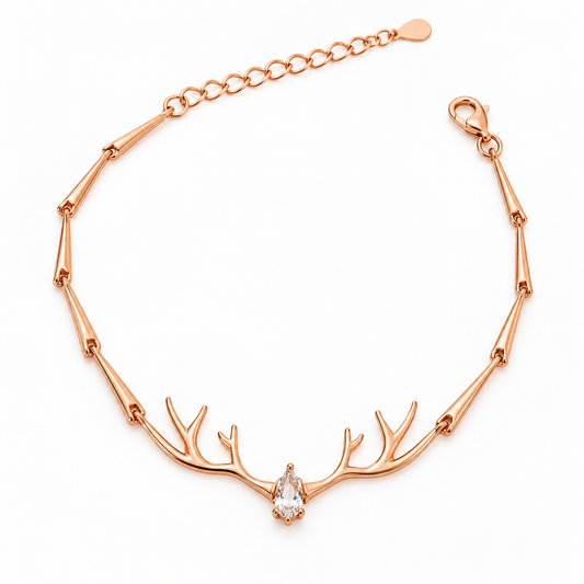 Rose gold silver bracelet with central antler motif and pear-cut stone on a plain white background.