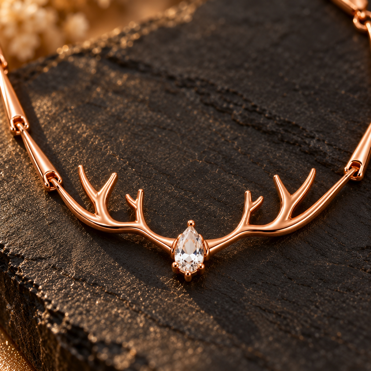 Macro view of the central pear-cut stone nestled inside the rose gold antler motif.
