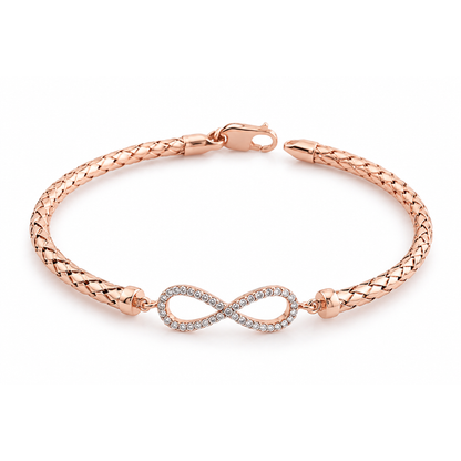 Rose gold woven mesh bracelet with pave cubic zirconia infinity motif centered on a clean white backdrop.