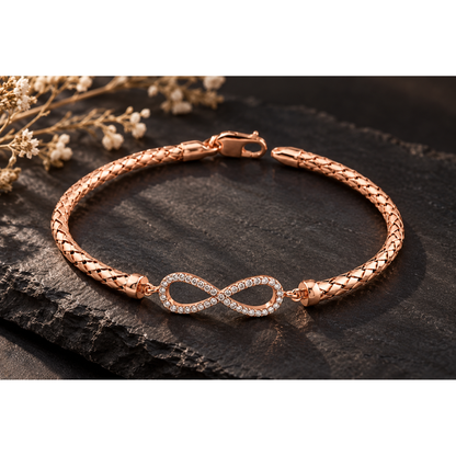 Rose gold silver bracelet with sparkling stones featured on dark matte slate backdrop.