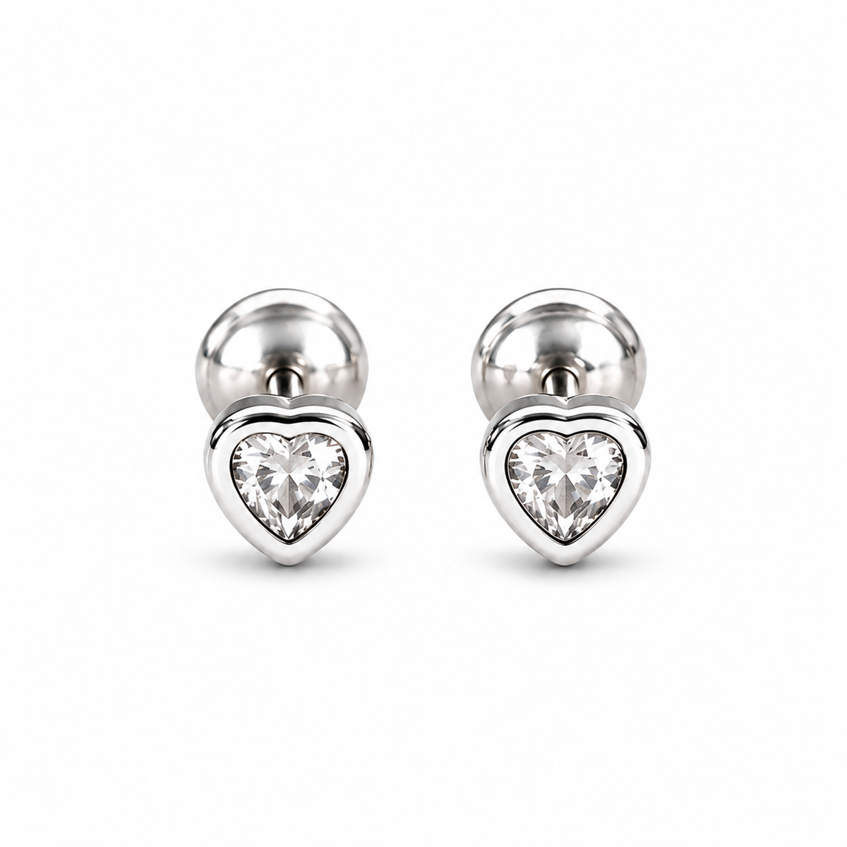 Pair of silver heart bezel stud earrings on a pure white background.