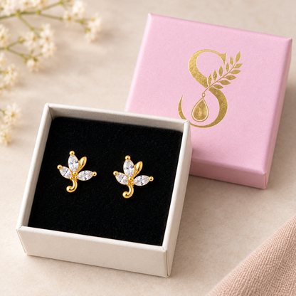 Gold leaf stud earrings presented inside the signature Silvanya pale pink box on black velvet.