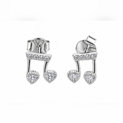 Pair of silver musical note stud earrings with cubic zirconia stones on a seamless white background.