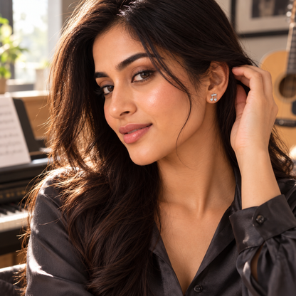 Woman wearing the silver musical note earring while tucking hair behind her ear.