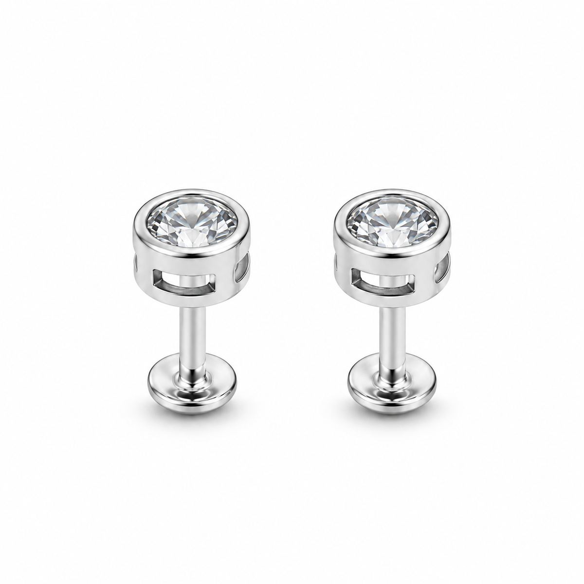 Pair of clear bezel-set silver stud earrings on a seamless white background.