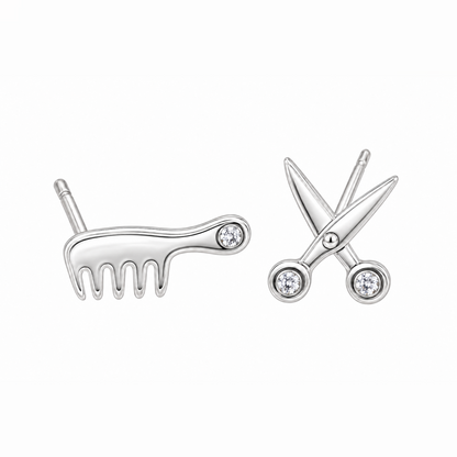 Pair of sterling silver stud earrings shaped like a comb and scissors on white background.