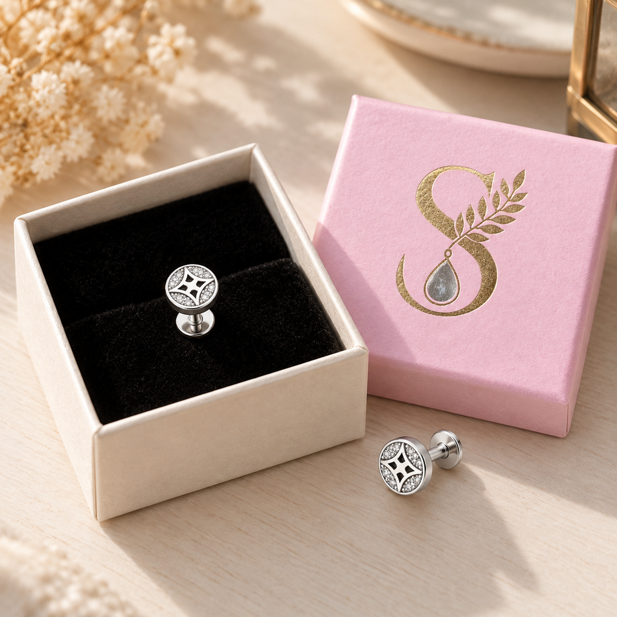 Silvanya small pale pink gift box open displaying velvet interior and a star silver stud earring.