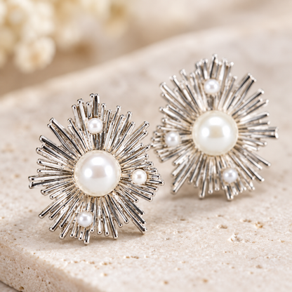 Detailed macro close-up showing the silver radiating texture and central pearl of the stud earring.