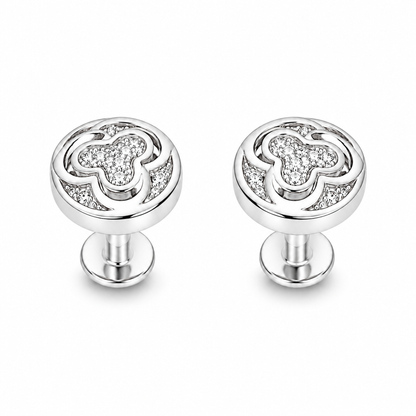 Pair of silver pave swirl stud earrings on a seamless white background