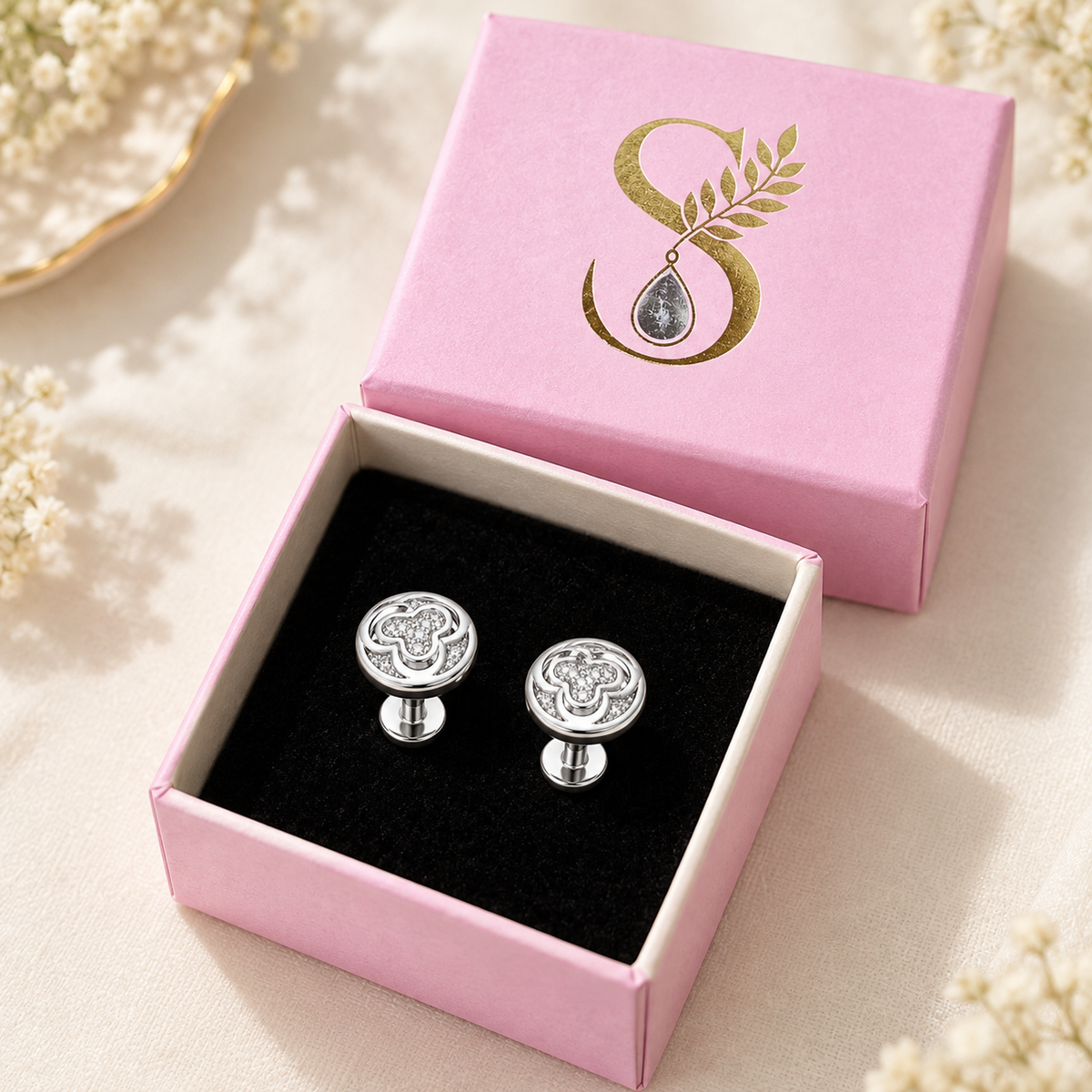 Silver pave stud earrings resting inside open Silvanya pink gift box