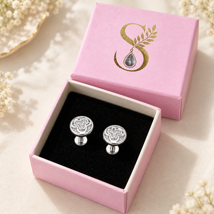 Silver pave stud earrings resting inside open Silvanya pink gift box
