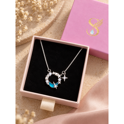 Silver celestial necklace in a pale pink Silvanya jewelry box with black velvet lining.