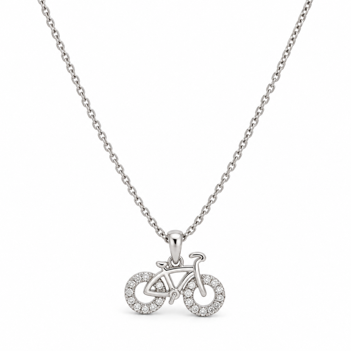 Sterling silver bicycle pendant necklace displayed centered against a seamless white studio background.