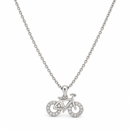 Sterling silver bicycle pendant necklace displayed centered against a seamless white studio background.