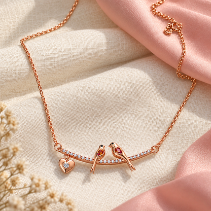 Rose gold silver necklace resting on a matte black slate backdrop.