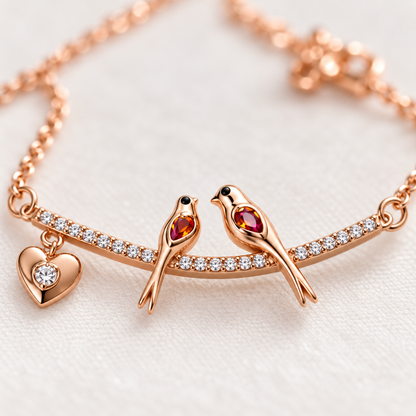 Macro shot detailing the lovebirds motif and pavé stones on rose gold necklace.