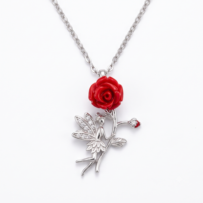 Sterling silver fairy pendant necklace with a red rose, centered on a seamless white background.