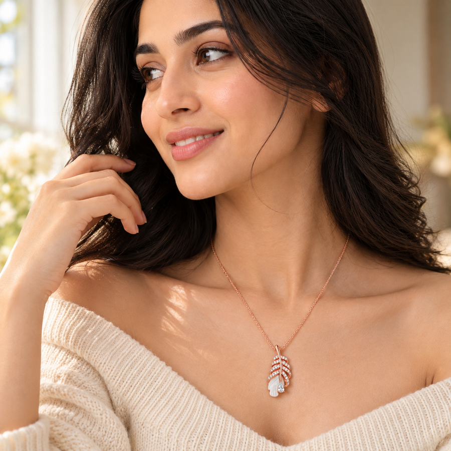 Woman smiling in a rose gold feather necklace