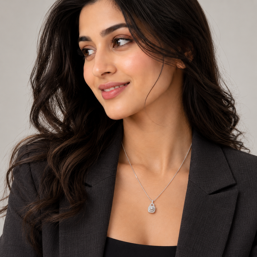 Woman in a black blazer wearing a silver halo pendant