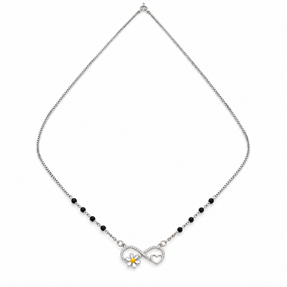 Sterling silver infinity necklace with black beads, pave stones, and a daisy motif on a white background.