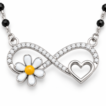 Detailed macro shot of an infinity pendant with cubic zirconia stones and a white enamelled daisy.
