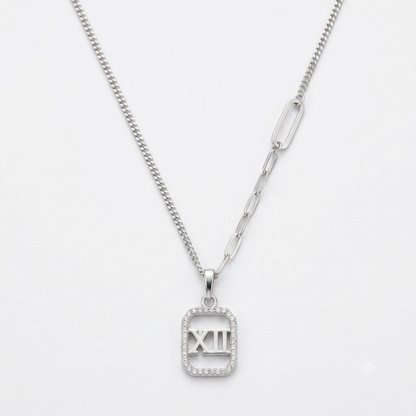 Silver Roman numeral XII mother of pearl pendant necklace flat lay on pure white background.