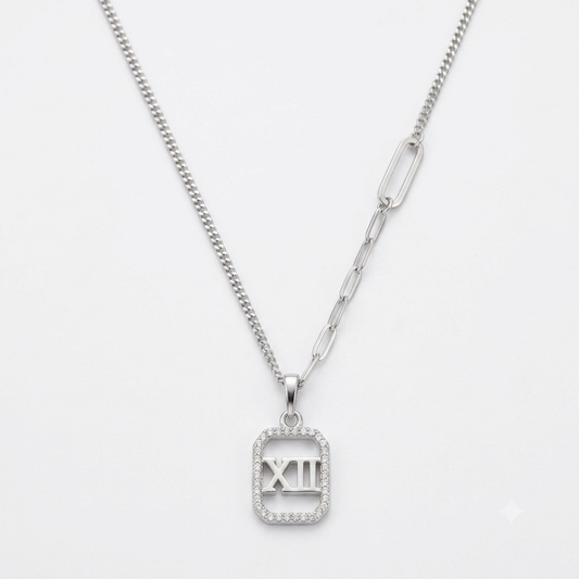 Silver Roman numeral XII mother of pearl pendant necklace flat lay on pure white background.