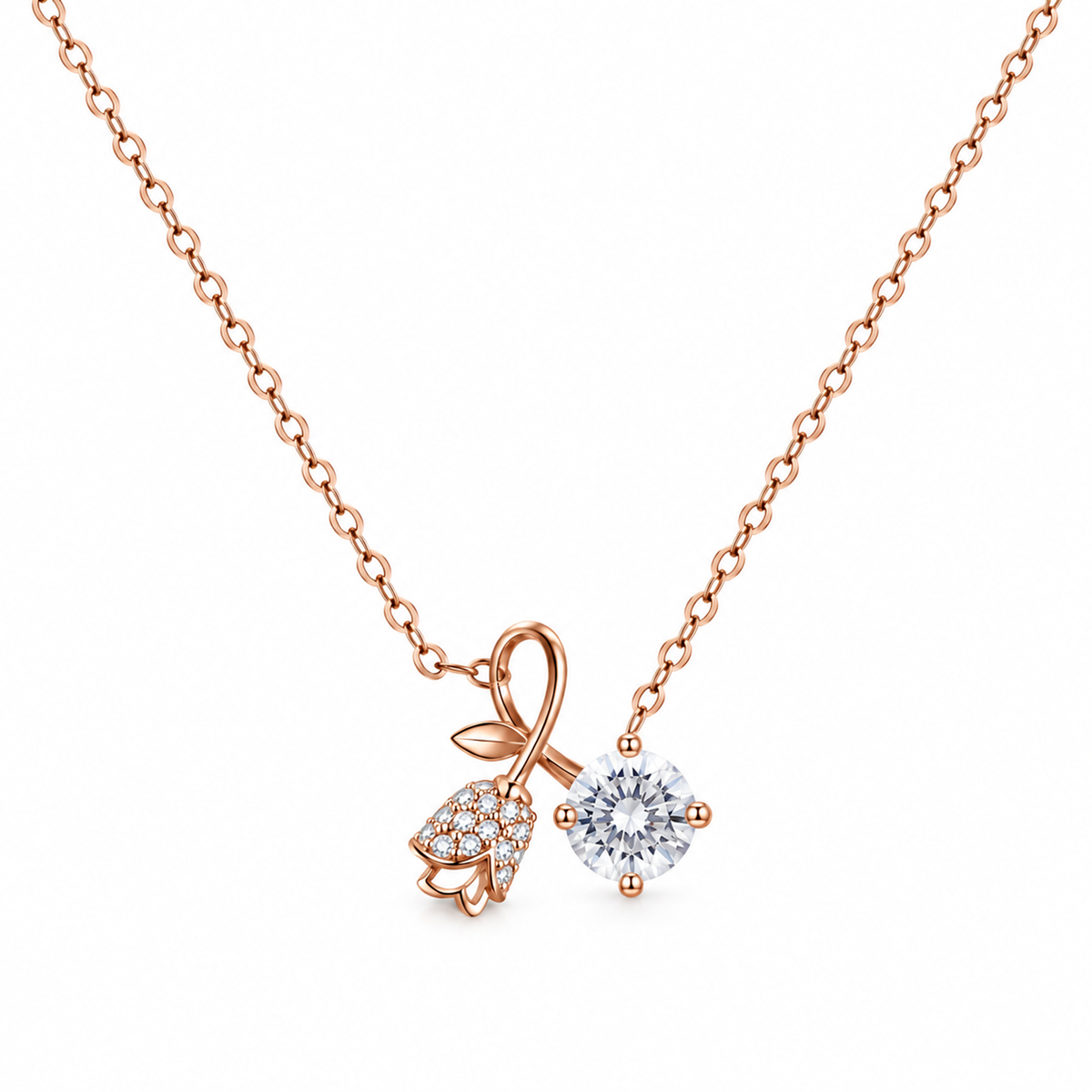 Rose gold silver chain with an asymmetrical rosebud motif and clear solitaire pendant on white background.
