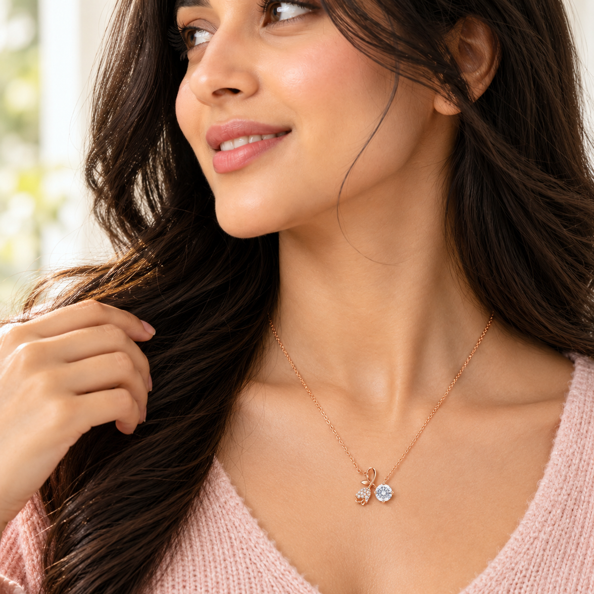 Close-up of Noya's collarbone showcasing the rose gold rosebud and solitaire pendant necklace.