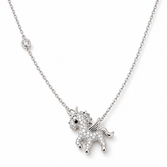 Silver unicorn pendant necklace with pave stones laid flat on a pure white background.