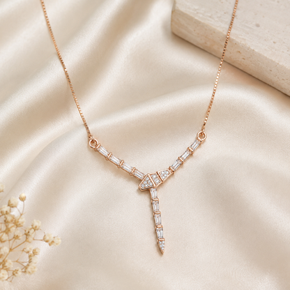 Rose gold Y-necklace with clear cubic zirconia centerpiece lying flat on a pure white background.