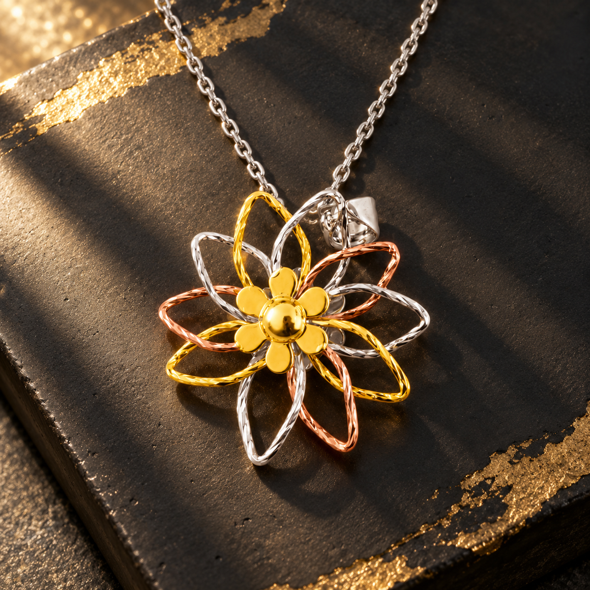 Close-up detail of the textured wire loops and central gold accent of the silver pendant.