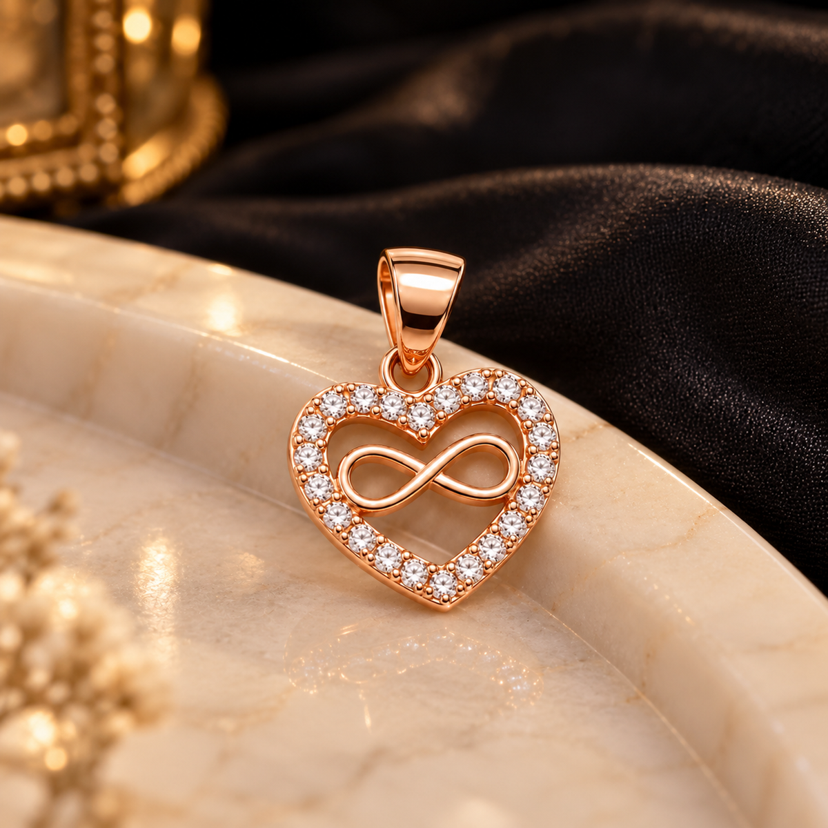 Rose gold pave heart pendant on ivory marble surface with dark silk background.