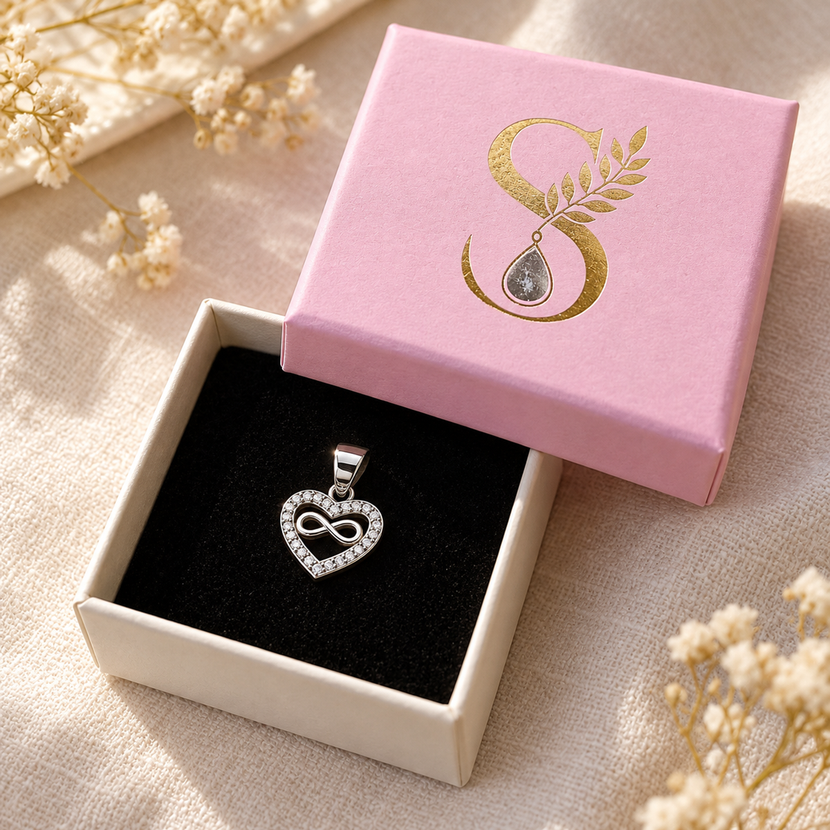 Silver pendant inside a pale pink Silvanya gift box with black velvet lining.