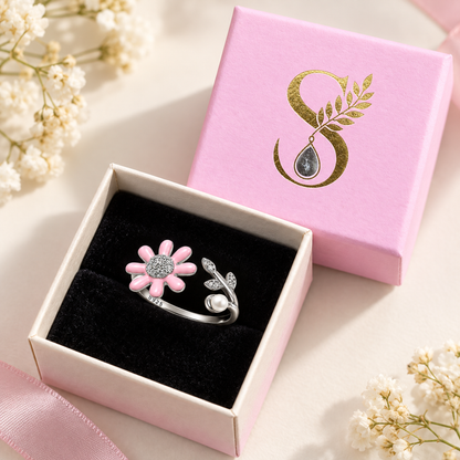 The silver daisy and pearl ring inside a small pale pink Silvanya box with a black velvet interior.