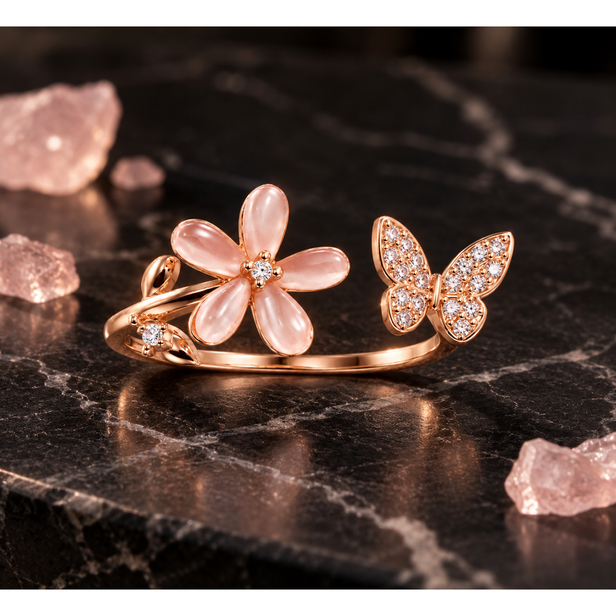 Rose gold floral bypass ring displayed on matte black marble surrounded by small quartz crystals.