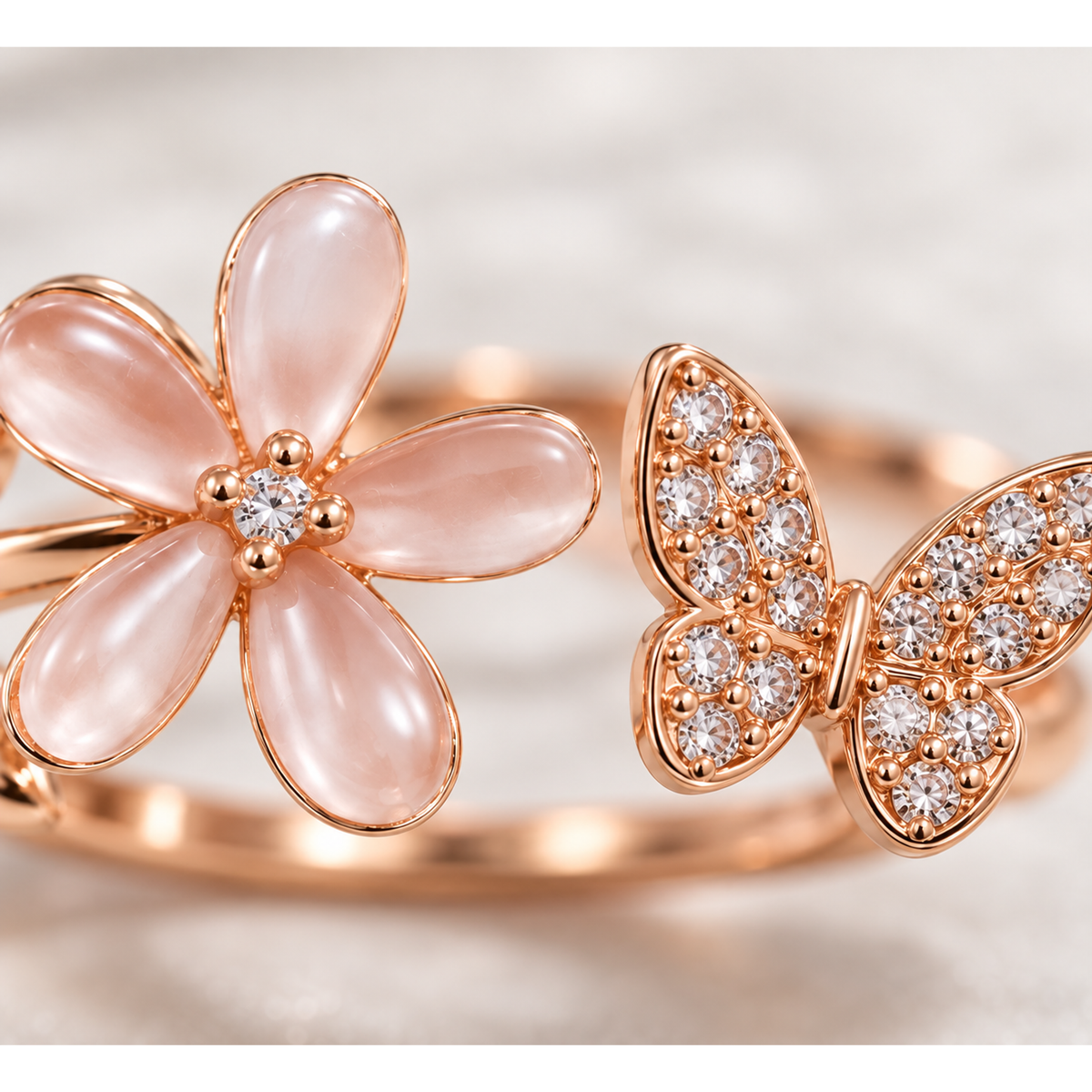 Macro close-up shot of pink resin flower petals and sparkling cubic zirconia butterfly on rose gold band.
