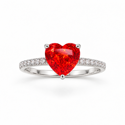 Sterling silver ring with a red heart stone on a seamless white background.