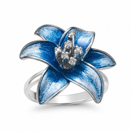 Sterling silver lily ring with blue enamelled petals on a pure white background.