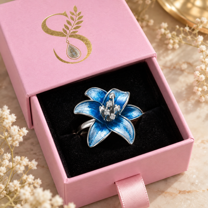 Blue lily silver ring presented in Silvanya magenta drawer packaging.