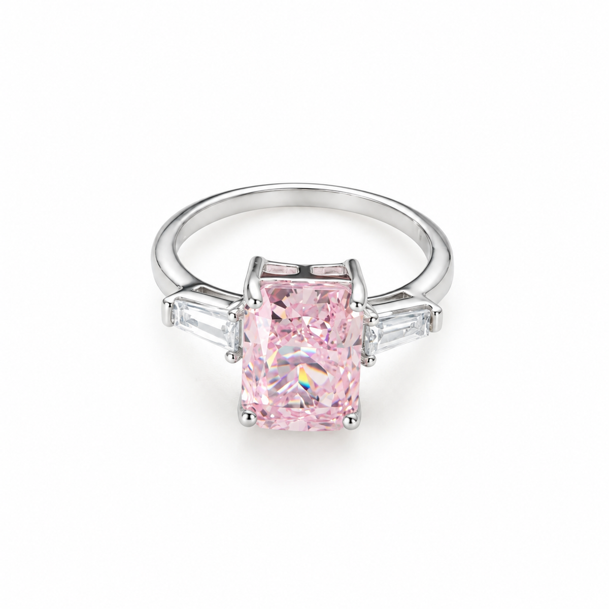 A sterling silver ring with a radiant-cut pink stone and clear side baguettes on a pure white background.