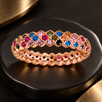 Noya wearing the rose gold rainbow eternity ring on her hand resting under her chin.