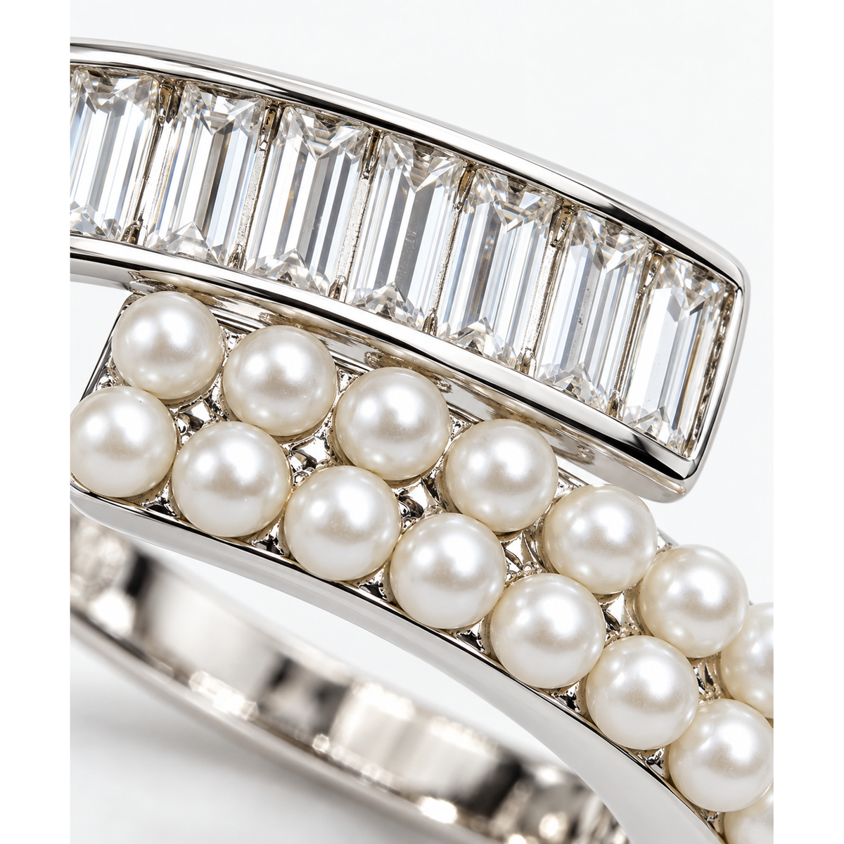 Macro close-up of seed pearls and baguette cubic zirconia on a silver ring.