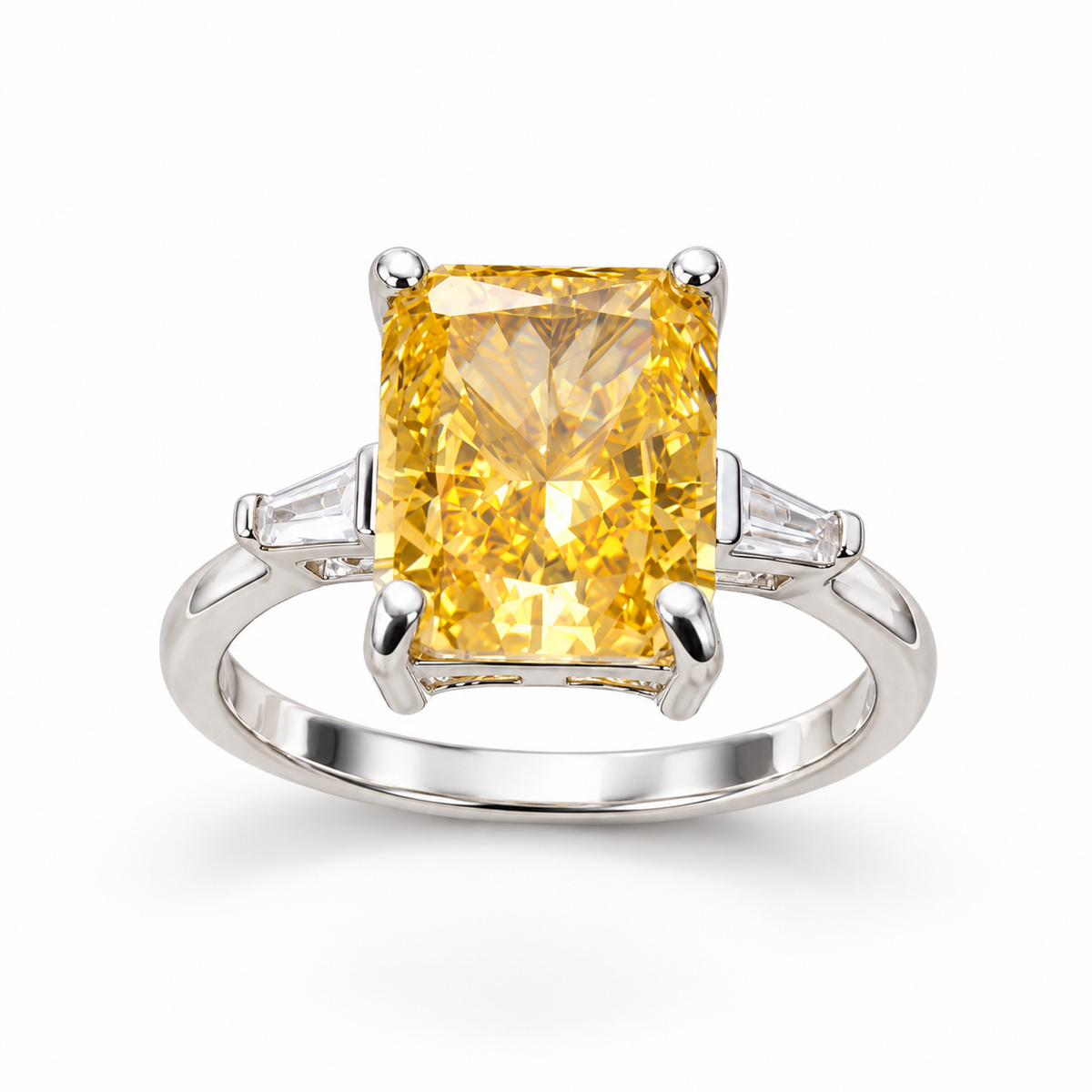 Polished silver ring with a large radiant-cut yellow gemstone and clear shoulder stones on a seamless white background.